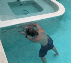 Pool leak detection expert underwater in pool