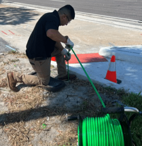 Sleuth employee cleaning restaurant drain system